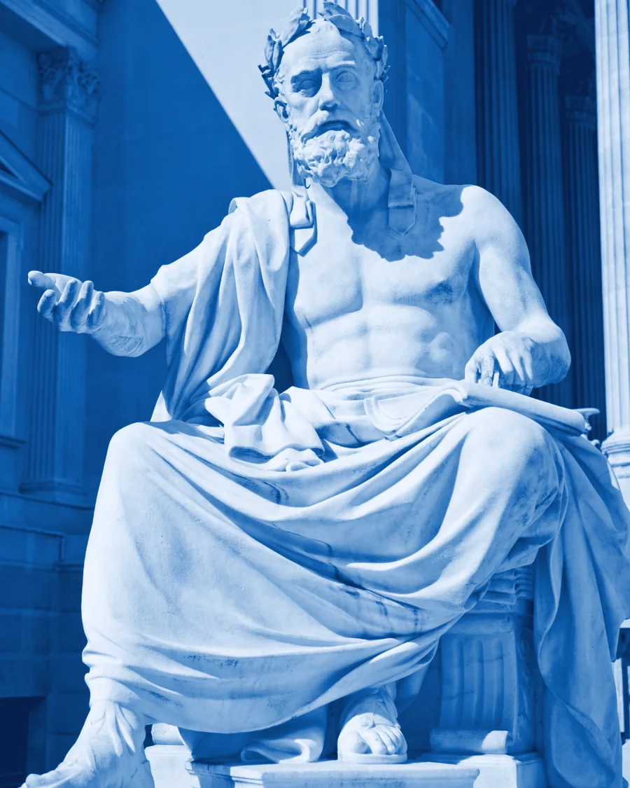Marble statue of a seated classical thinker, hand open as if speaking
